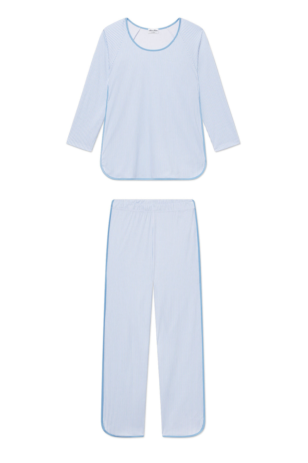 The Pima Long-Long Set in Classic Blue Oxford Print features a light blue and white striped pajama set with a long-sleeve top and matching pants, crafted from soft Pima cotton with rounded edges and blue piping, shown laid flat on a white background.