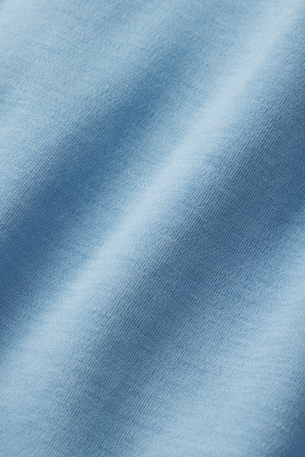Close-up of the Pima Scallop Robe in Serene Blue, crafted from 100% Pima cotton with a smooth texture and a subtle diagonal fold.