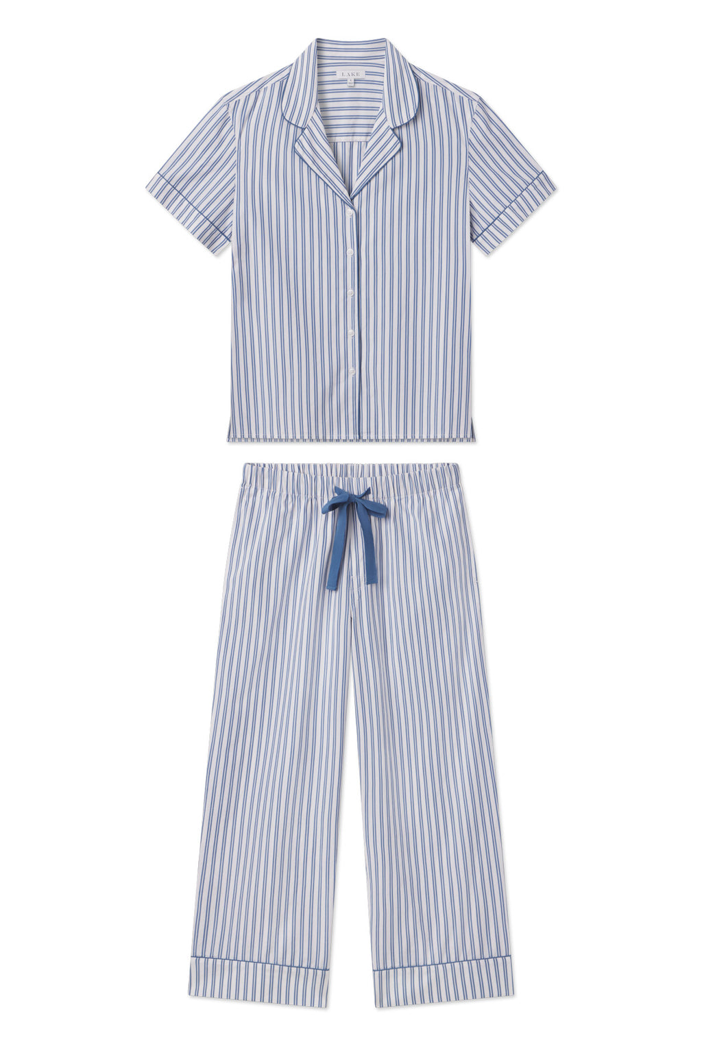 The Poplin Chloe Pajama Set in Seaport Shoreline Stripe is made from soft cotton poplin and includes a short-sleeve, button-up collared top and wide-leg pants with a blue drawstring.
