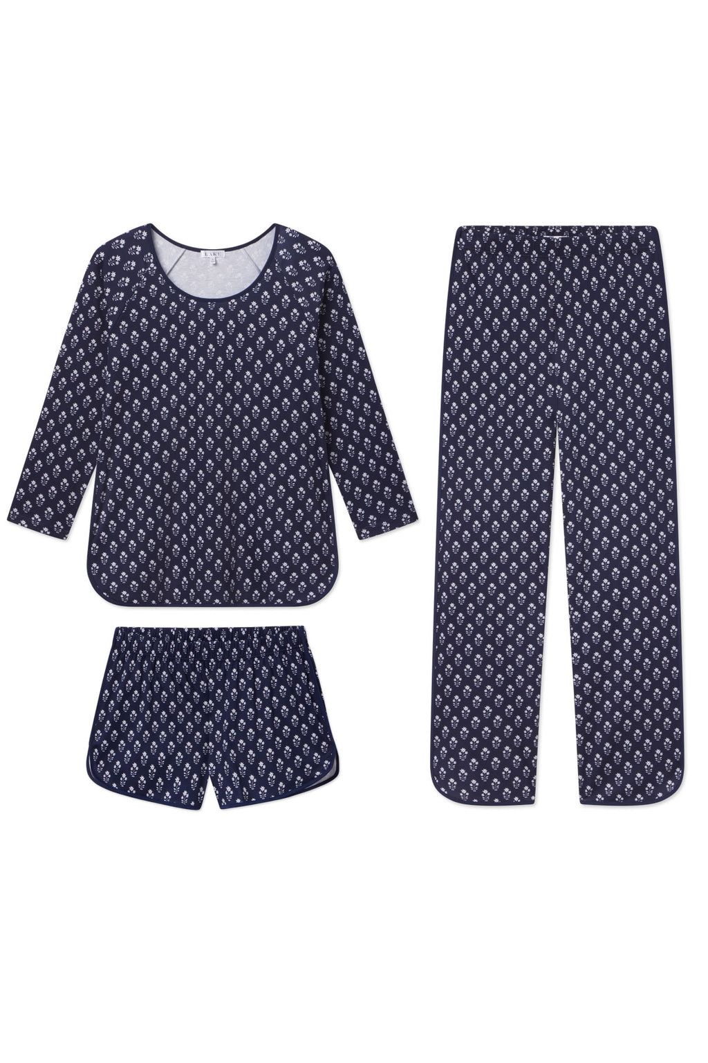 The Pima Long Sleeve Bundle in English Navy Posy features a soft Pima cotton pajama set with petite white bouquets, including a long-sleeve top, long pants, and matching shorts, all shown flat on a white background.