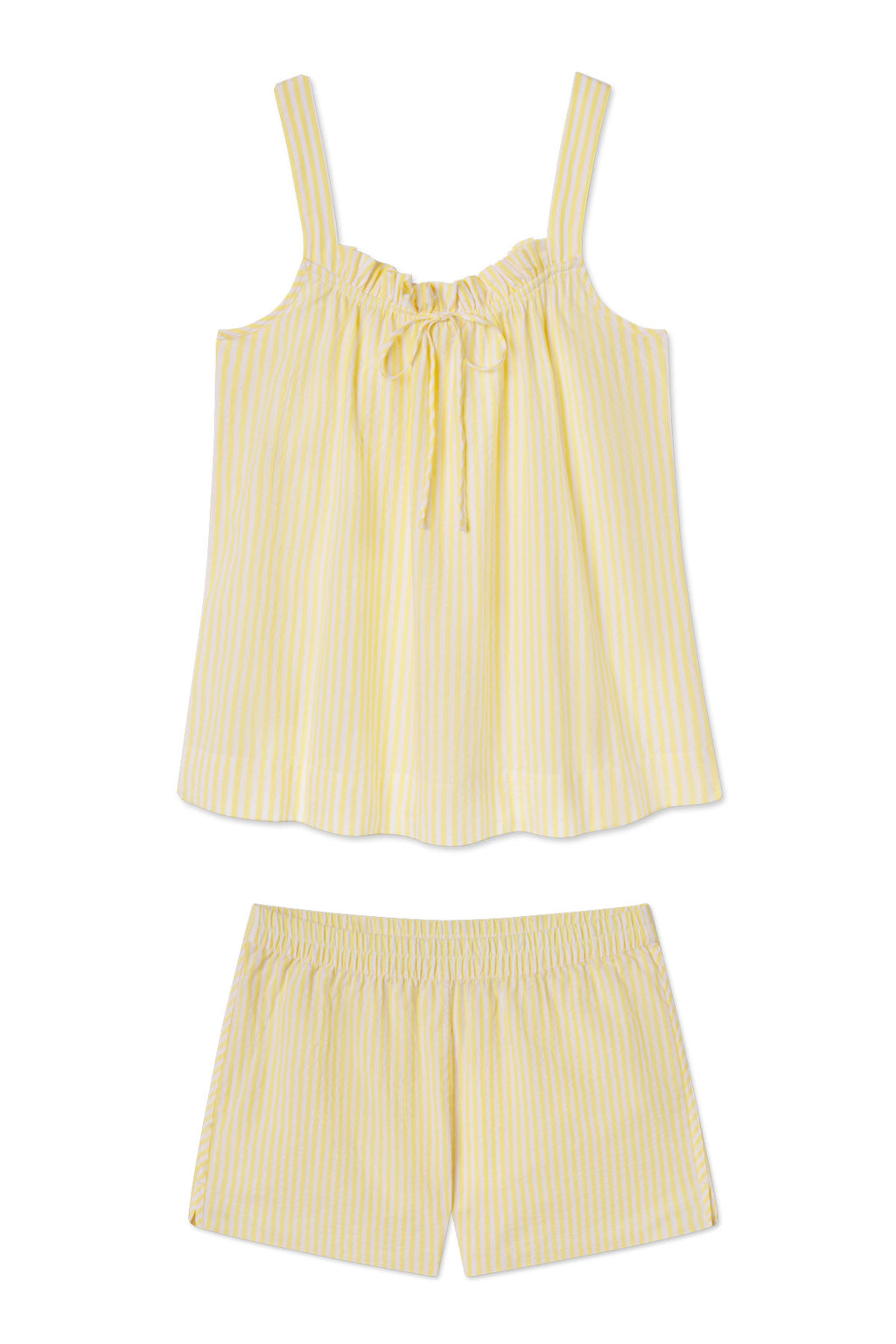 The Alice Shorts Set in Zest Seersucker is a yellow and white striped pajama set with a sleeveless, ruffled top, shoulder straps, front bow, and elastic-waist shorts, all crafted from soft Pima cotton.