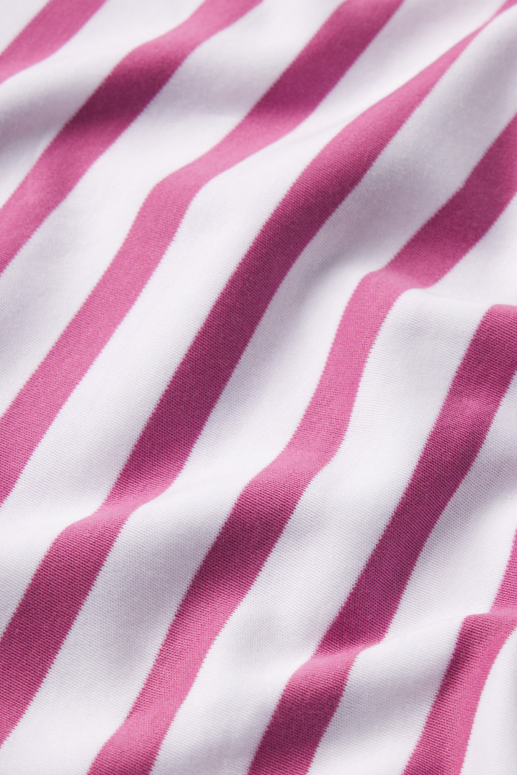 Close-up of the Pima Long-Long Set in Camellia Stripe, showing diagonal pink and white stripes with soft folds and a smooth Pima cotton texture.