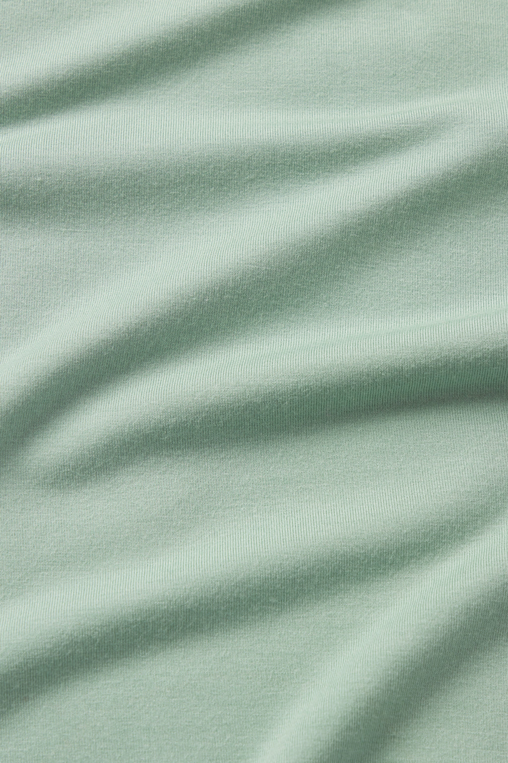 Close-up of Granite Green DreamModal Ribbon Short-Long Set fabric, featuring a soft, ribbed texture with gentle diagonal folds across the surface.