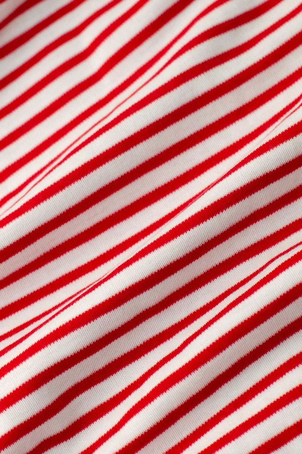 Close-up of the Pima Short Robe in Classic Red Voyager Stripe, showcasing its soft Pima cotton fabric with evenly spaced diagonal red and white stripes, and gentle folds that highlight the robe