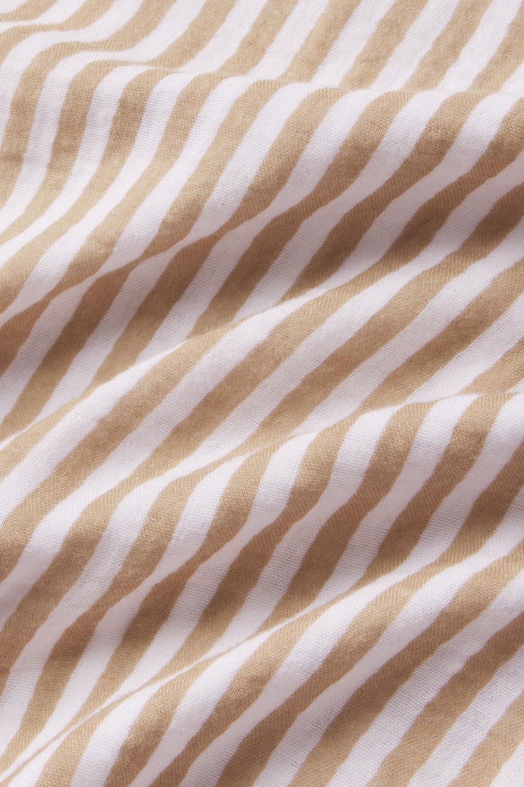 Close-up of the Hamptons Pants Set in Sandstone Awning Stripe, featuring soft fabric with diagonal beige and white stripes and gentle folds—perfect for hot sleepers.