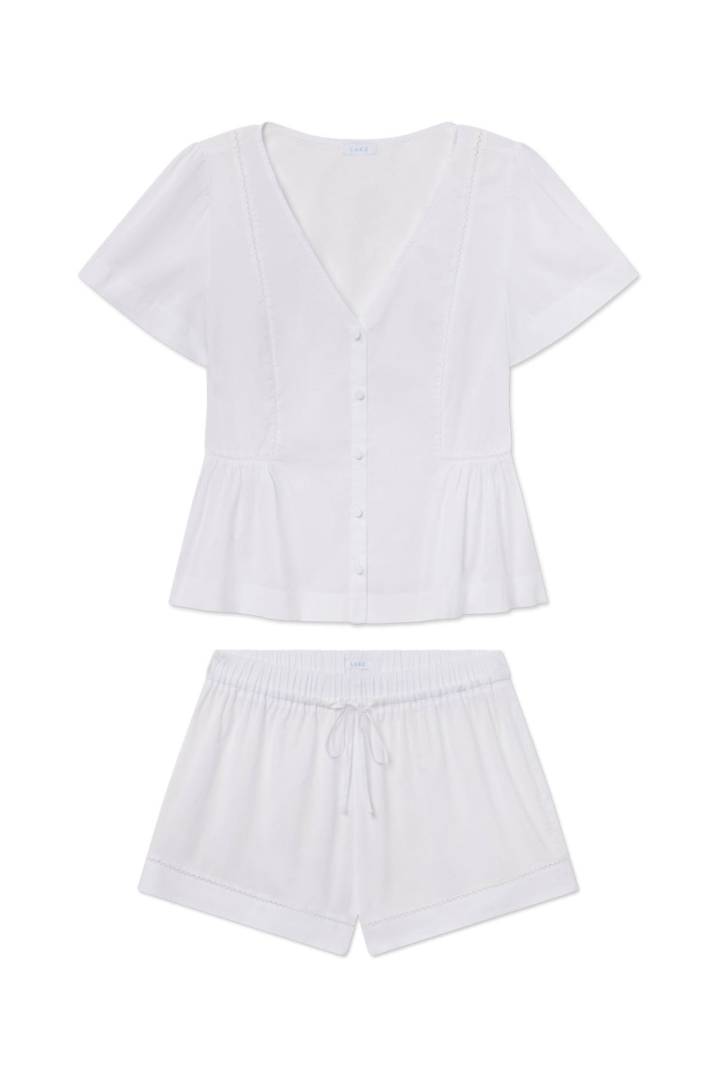White button-front top with puffed sleeves and matching drawstring shorts with decorative stitching.