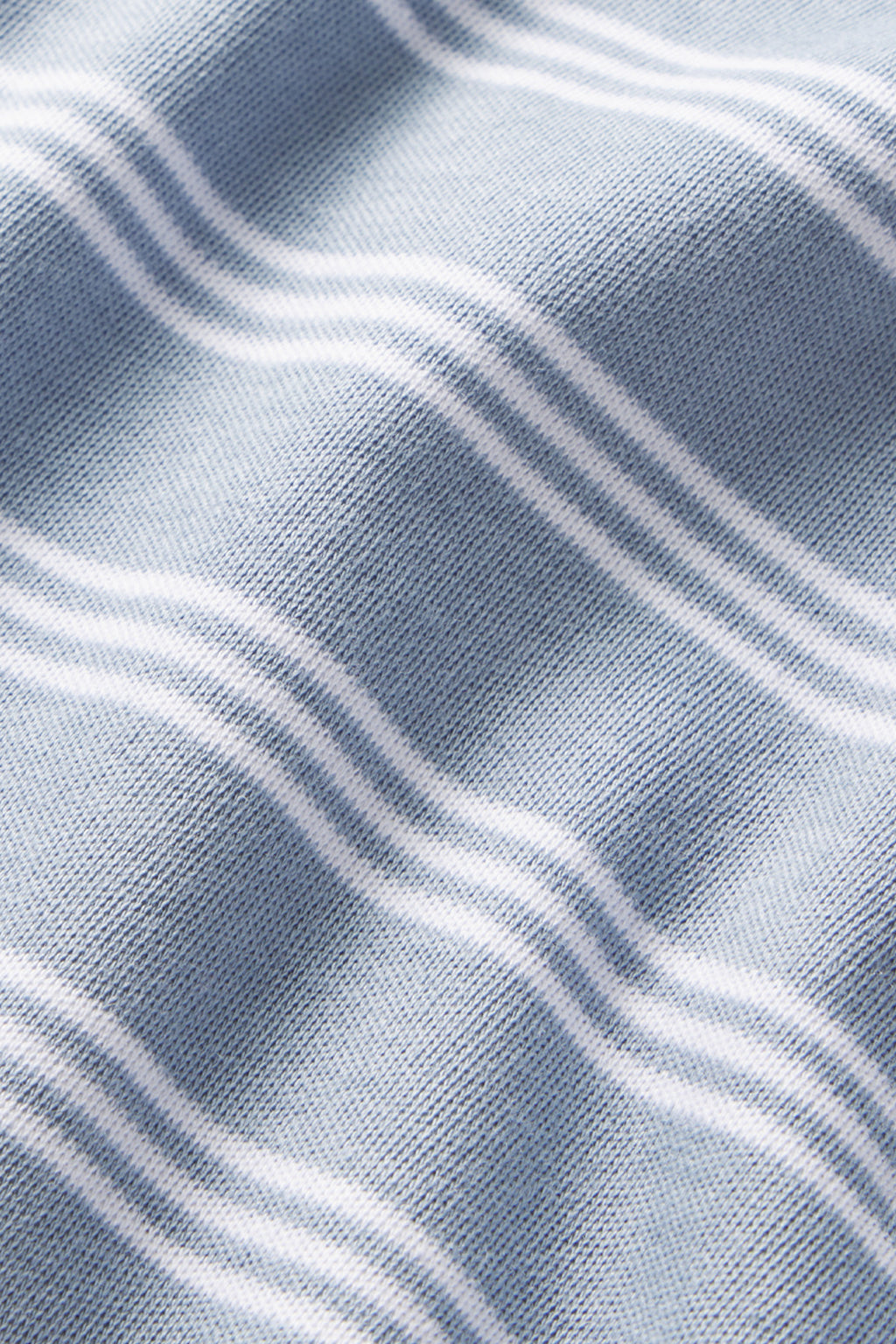 Close-up of the Pima Long-Long Set in Dusty Blue Stripe, made from 100% Pima cotton with a soft texture and white triple horizontal stripes forming a wave pattern. Fabric is shown gently folded.