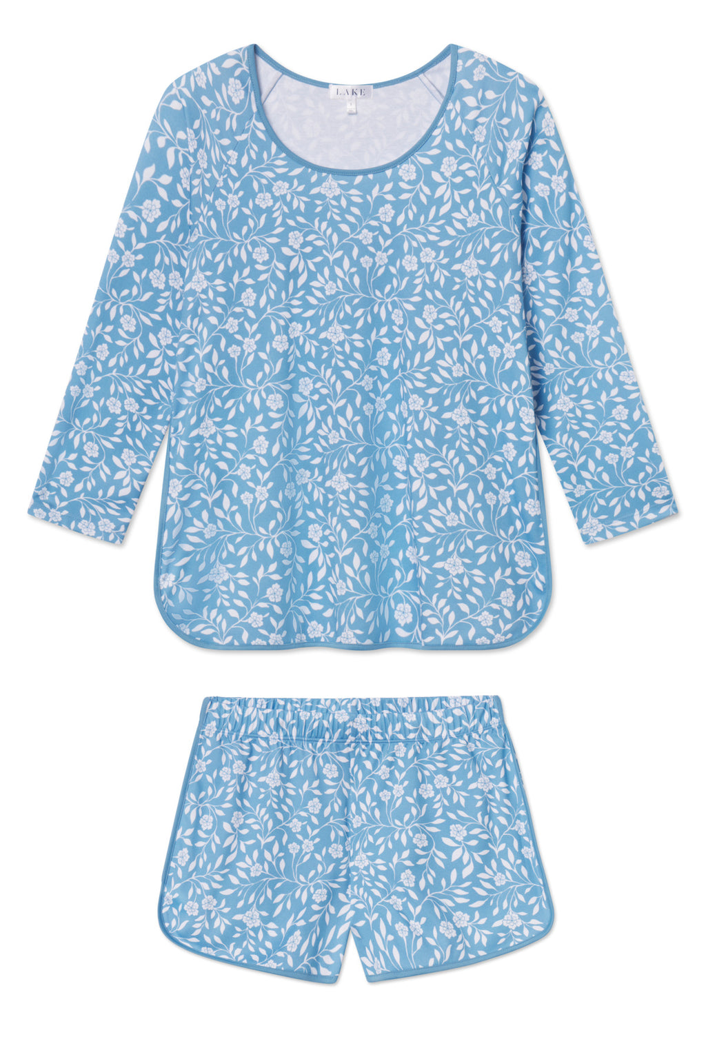 The Pima Long-Short Set in Serene Blue Cecil Floral is a women’s sleepwear set with a long-sleeve top and matching elastic-waist shorts in soft Pima cotton, featuring a white floral pattern.