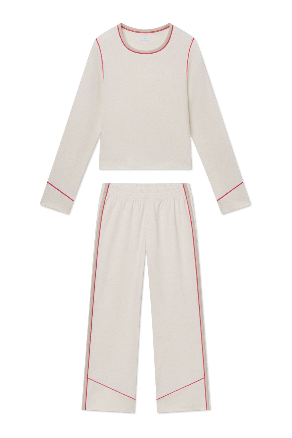 Cream knit two-piece set with long-sleeve top and wide-leg pants, both trimmed with pink piping.