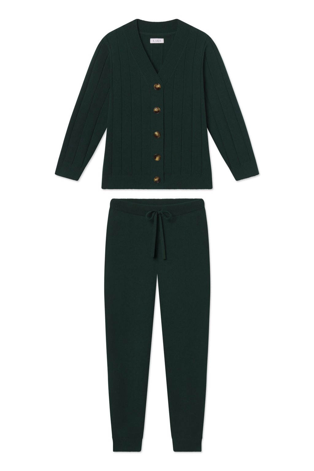 The Vesper Jogger Set in Conifer is a matching dark green knit lounge set featuring a cozy cardigan with brown buttons and long sleeves, paired with drawstring jogger-style pants.