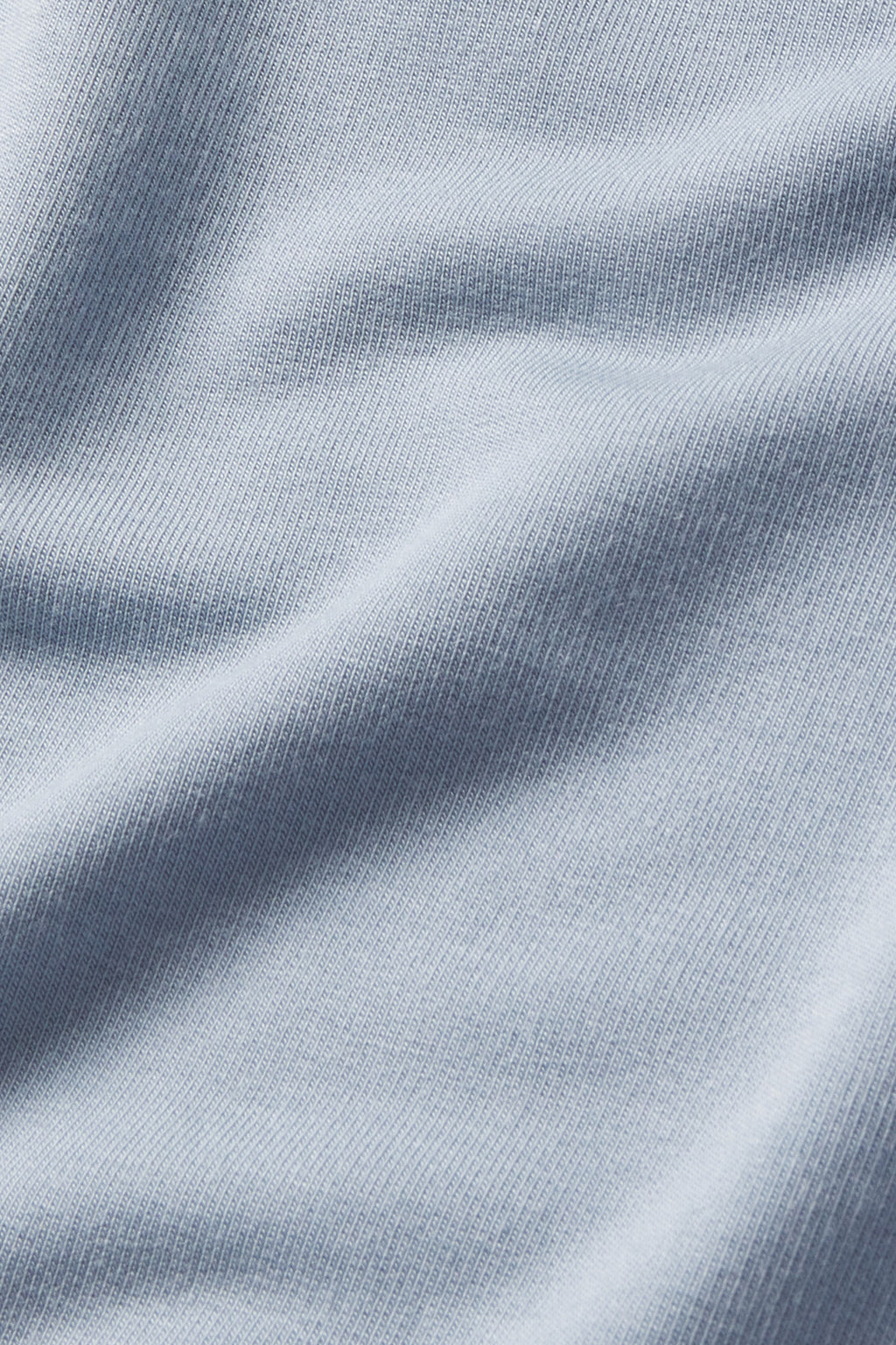 Close-up of Dusty Blue fabric with a fine knit texture, showing soft folds and subtle shadows—ideal for the Relax Pants Set in Dusty Blue.