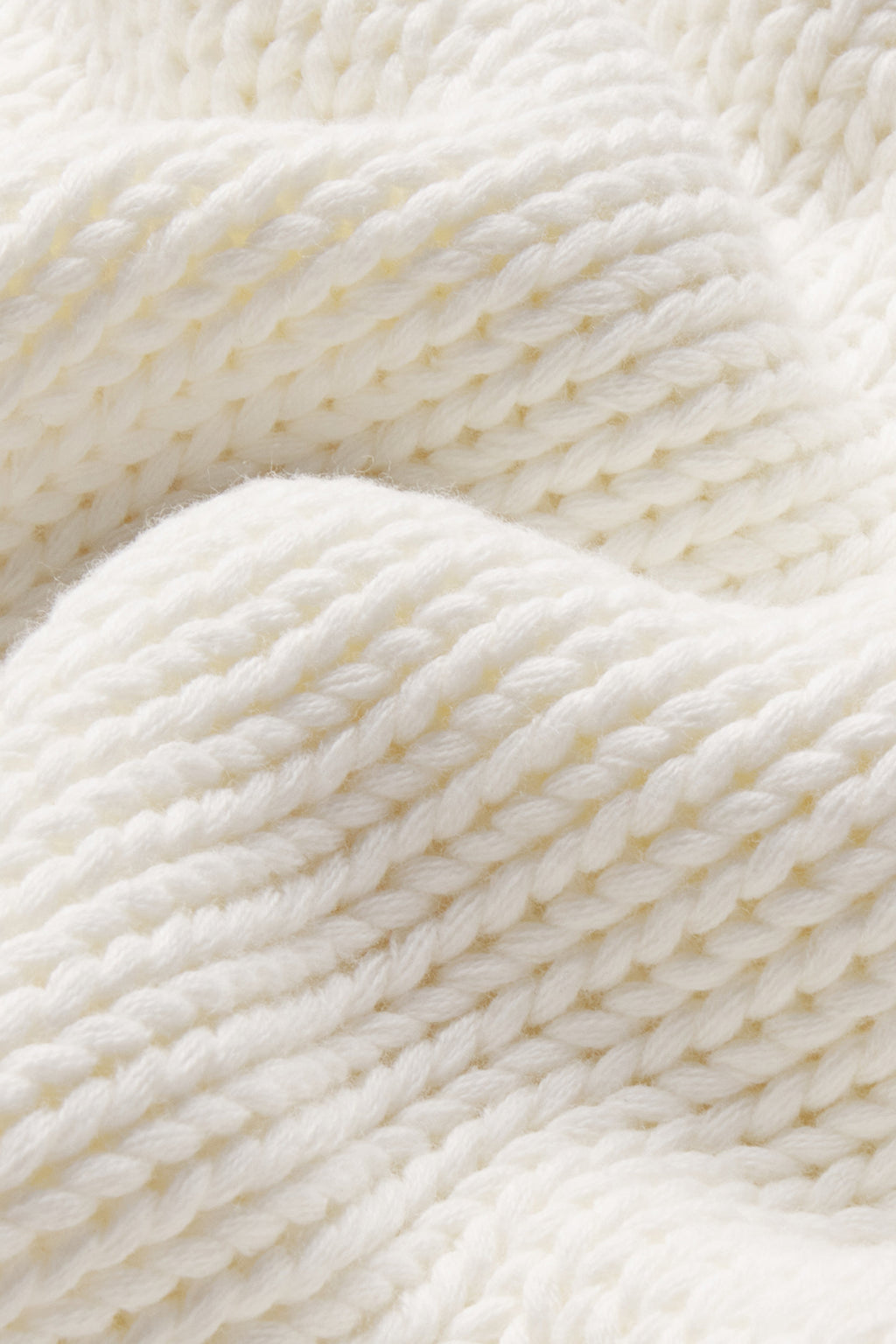 Close-up of the Jane Cotton Sweater in Ivory, featuring a chunky knit and soft, textured surface with cozy folds.