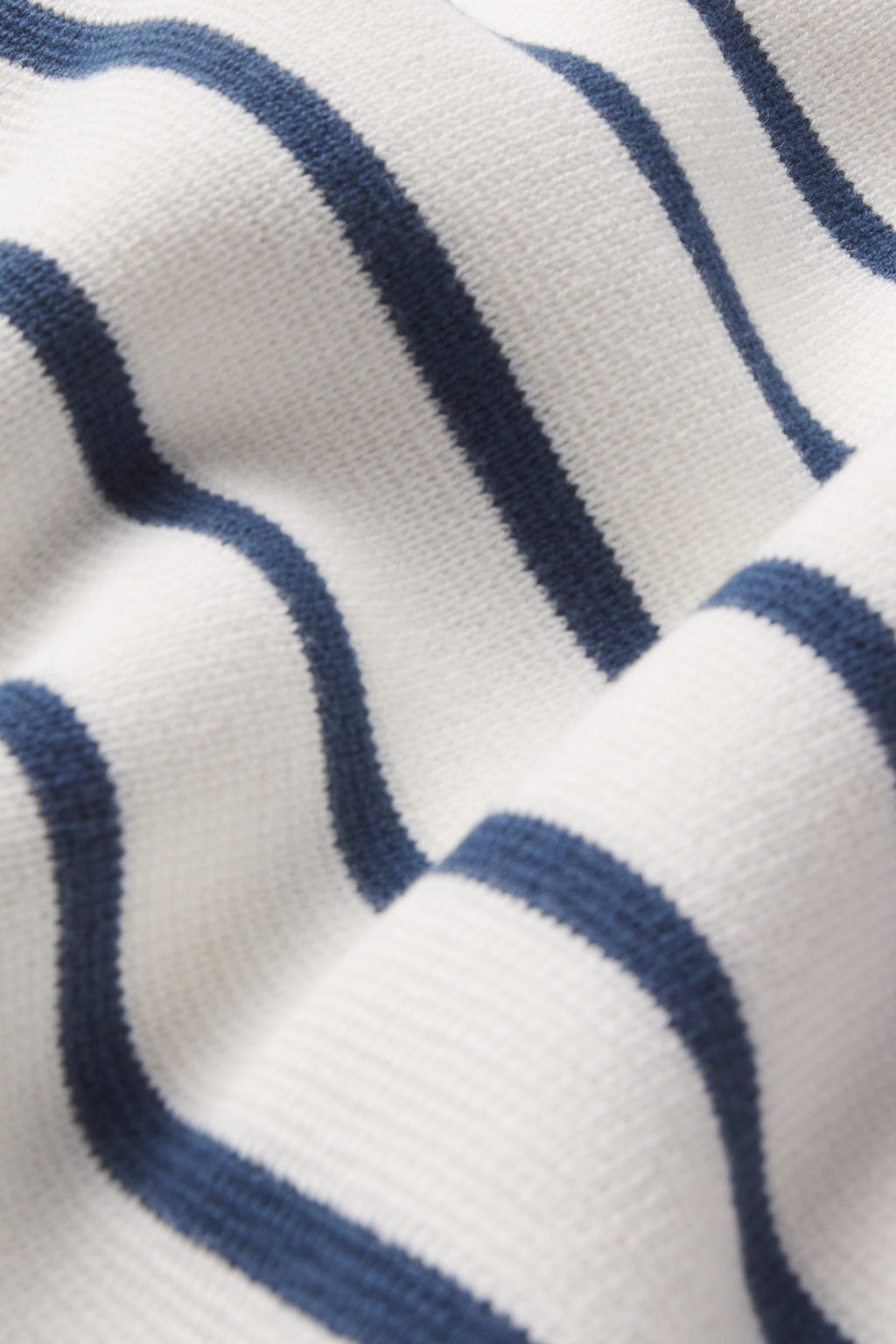Close-up of the Lydia Cotton Sweater in Nautical Stripe, highlighting navy stripes on off-white 100% cotton with soft folds that create gentle waves in the fabric.