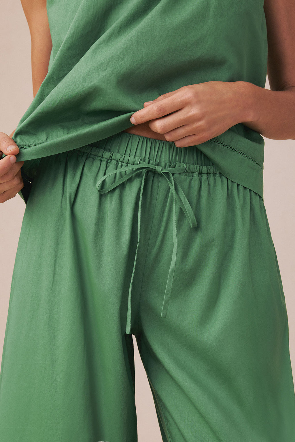 Green tank top and long pants set with drawstring waist, shown on model from mid-torso down.