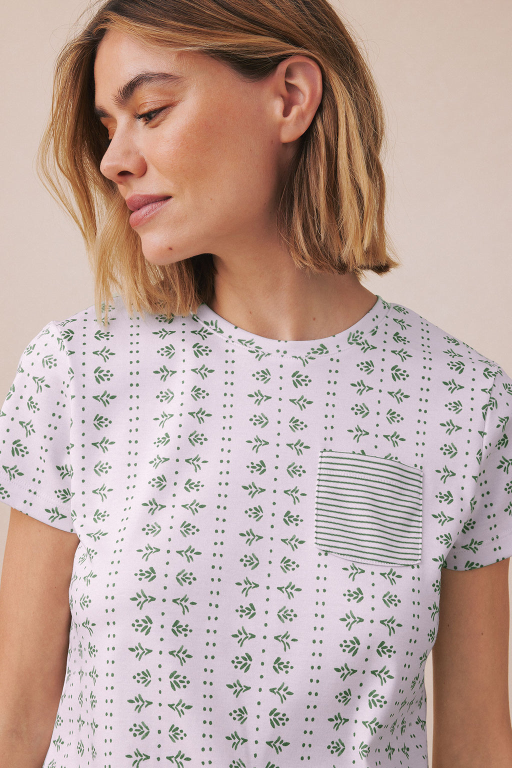 Lavender crew neck pajama top with green leaf and dot pattern, striped chest pocket.