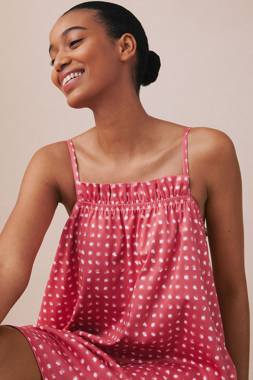 Red and white checked nightgown with ruffled neckline and thin straps on model.