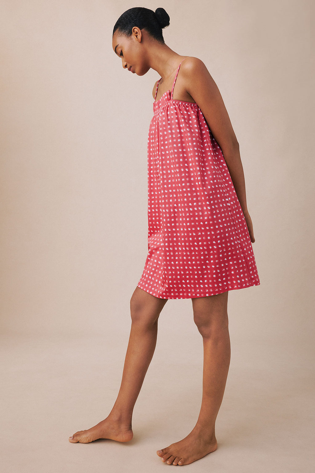 Coral pink brushed check nightgown with thin straps and ruffled neckline, shown on model against neutral background.