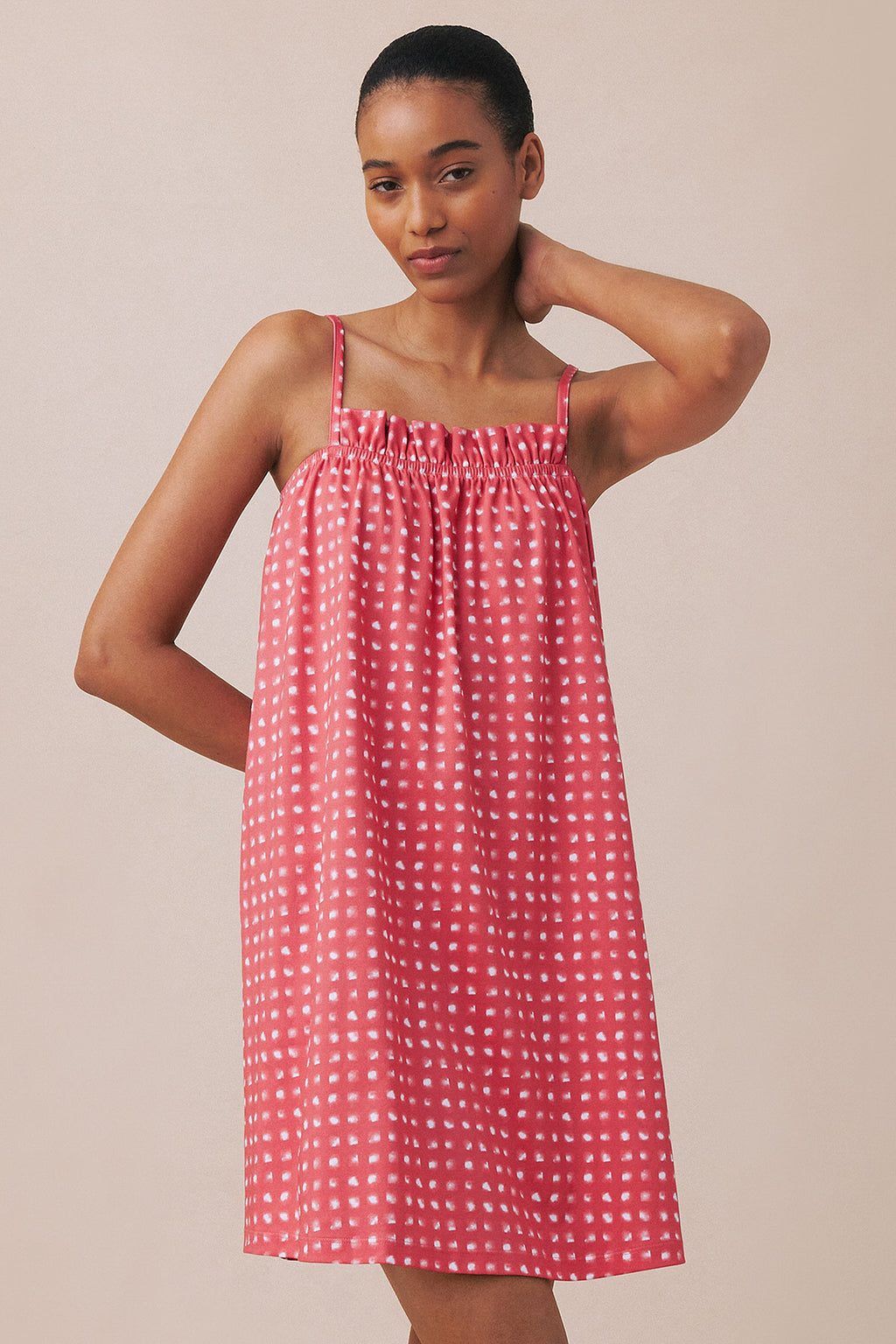 Pink and white checked nightgown with ruffle neckline and thin straps on model.