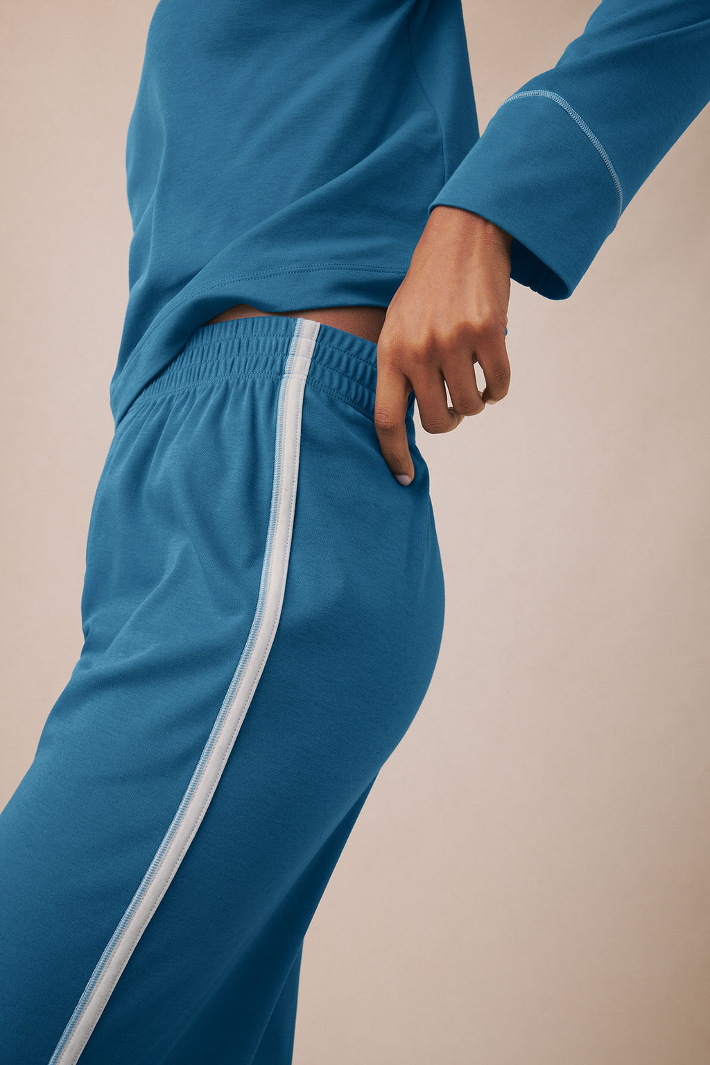 Blue long-sleeve top and matching pants with white side stripe detail on pants.