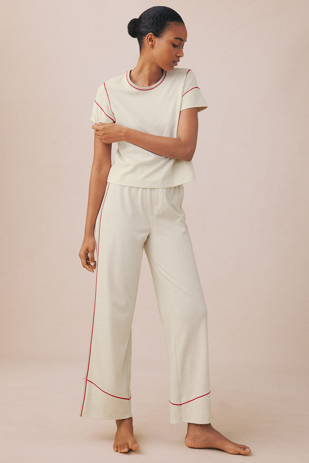 Cream knit set with red trim consisting of short-sleeve crew neck tee and wide-leg cropped pants.