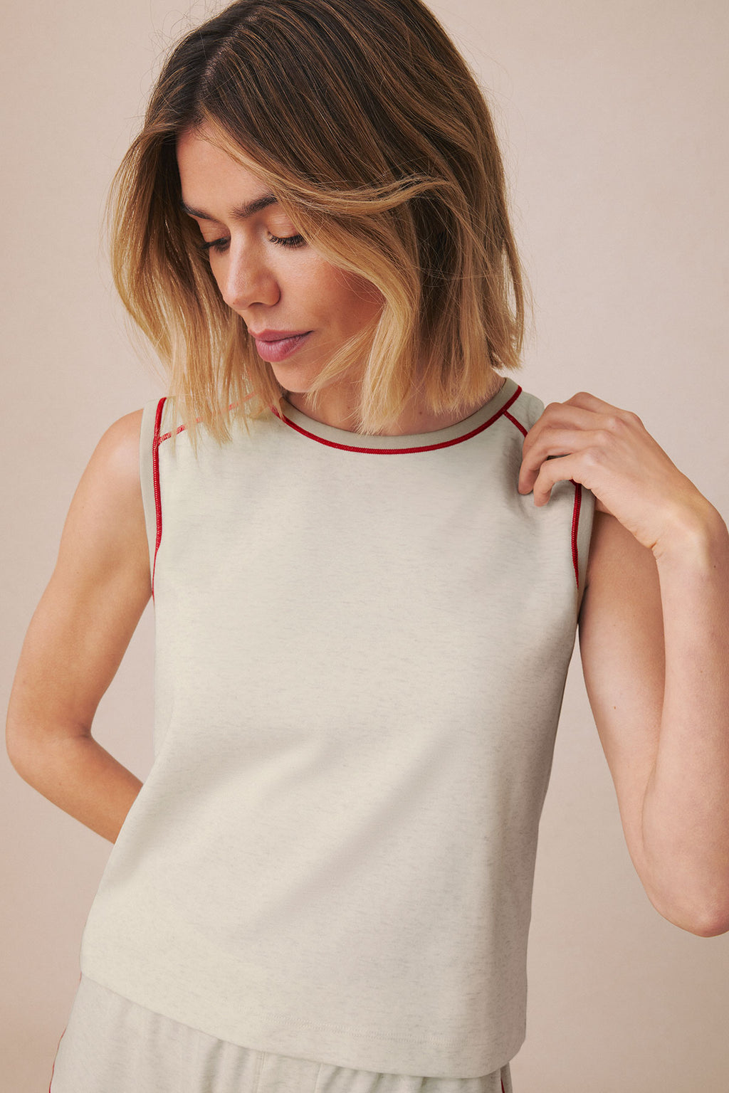Stone heather sleeveless tank top with burgundy contrast trim at neckline and armholes.