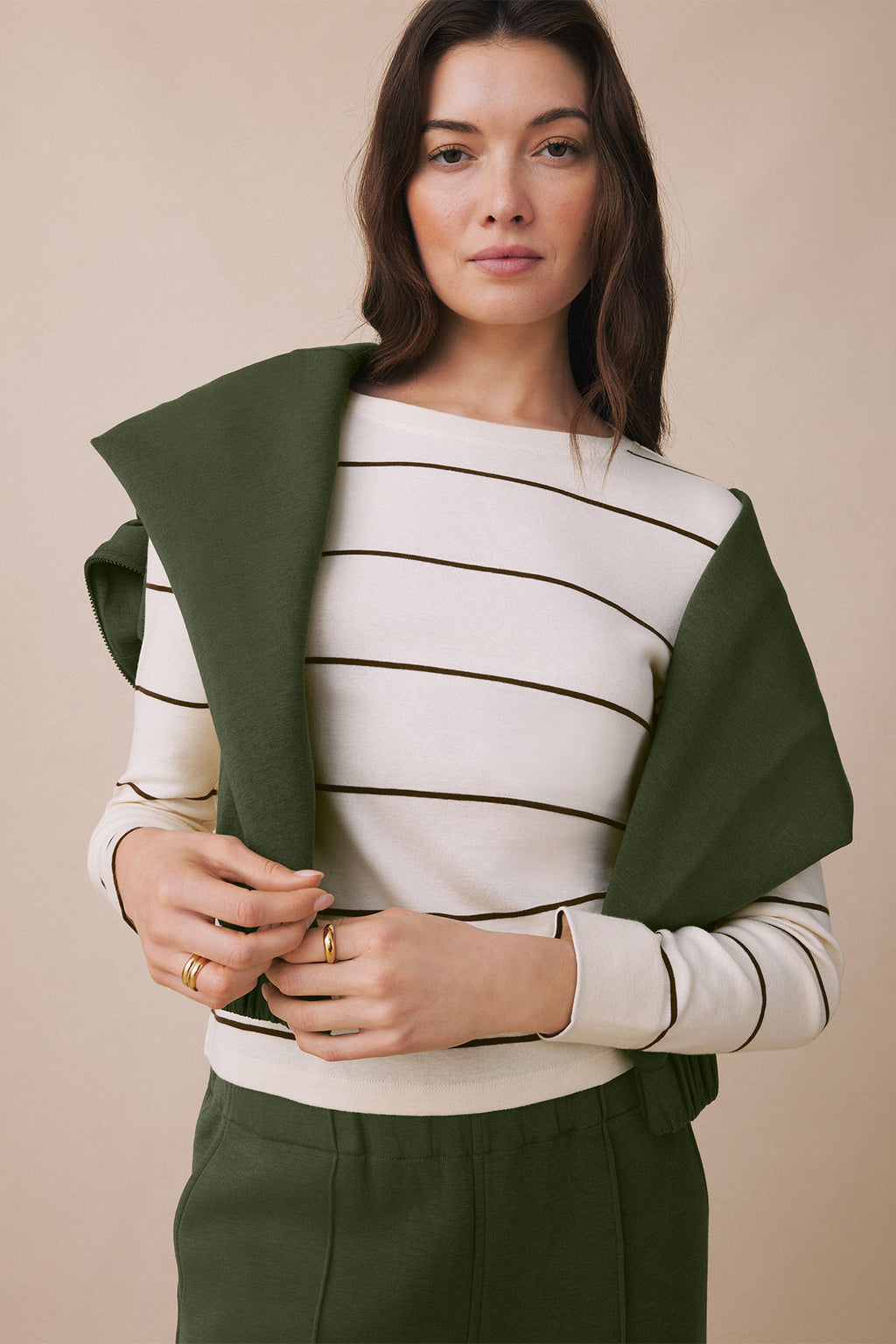 Long sleeve tee with cream and dark brown horizontal stripes, olive green sleeves, crew neckline.