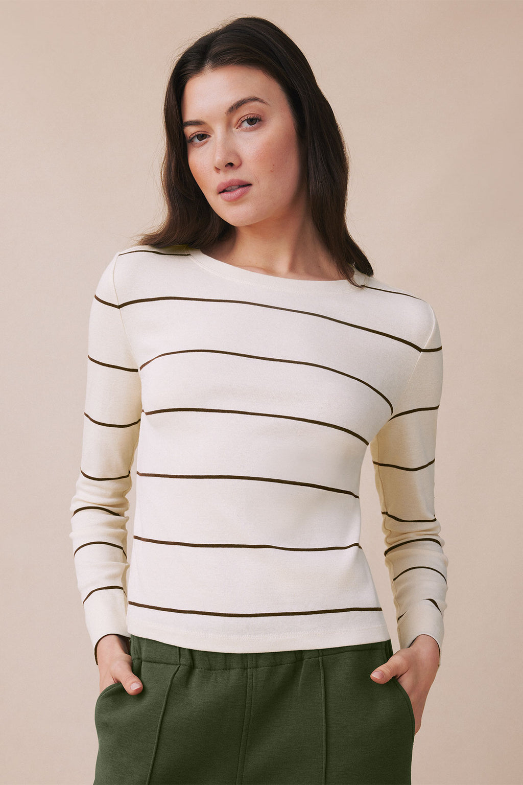 Cream long sleeve tee with horizontal cocoa stripes and crew neckline.