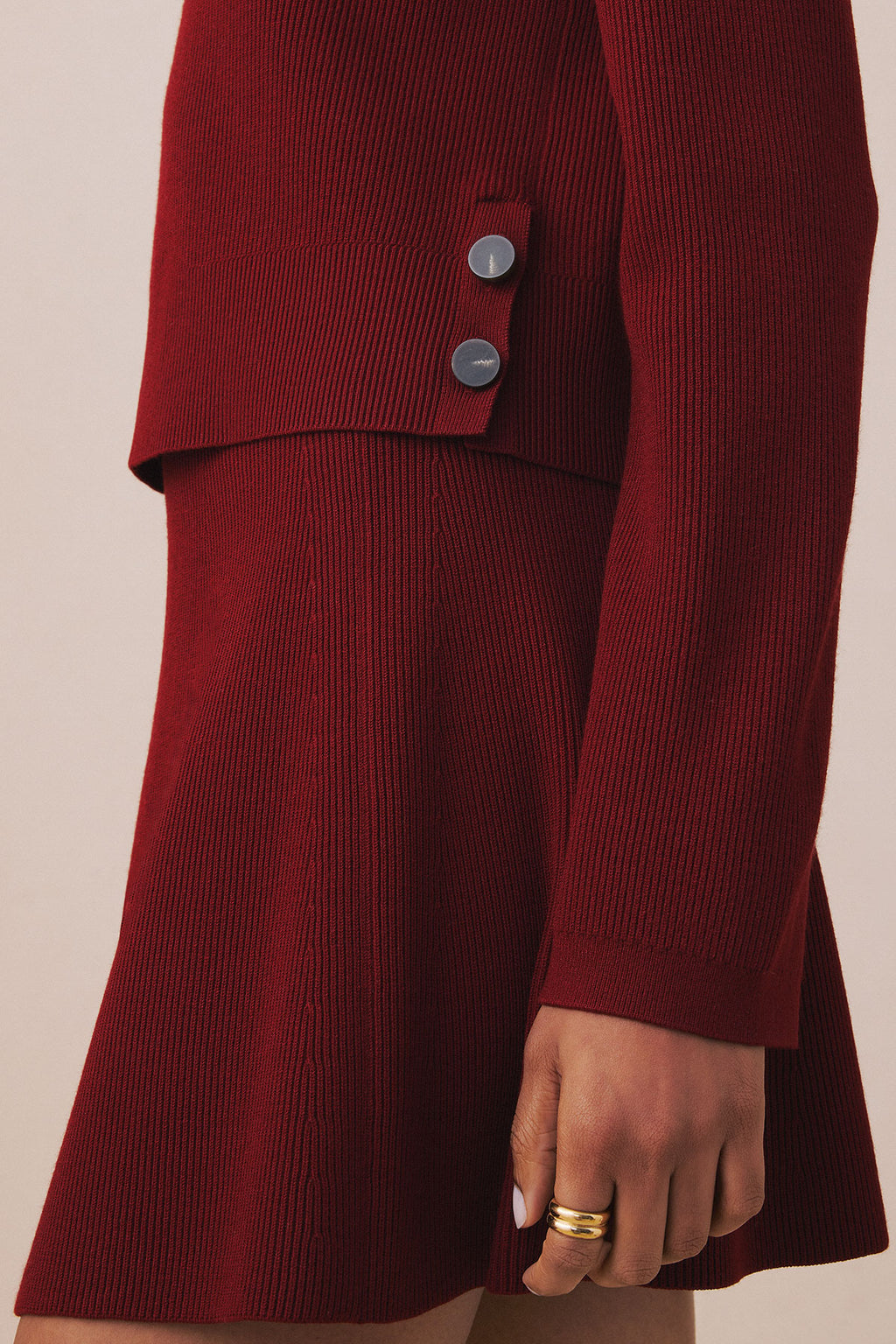 Deep red ribbed knit skirt set with button-front top and A-line skirt silhouette.