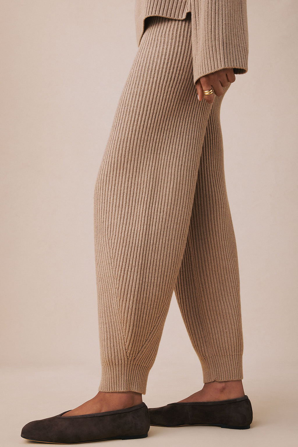 Fawn heather ribbed jogger pants with elastic cuffs, shown with matching ribbed sweater and black slip-on shoes.