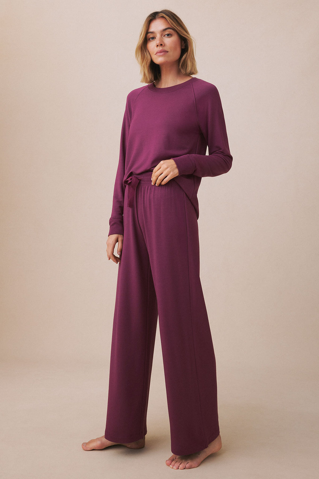 Woman wearing a fig-colored long-sleeve top and matching wide-leg pants with drawstring waist.