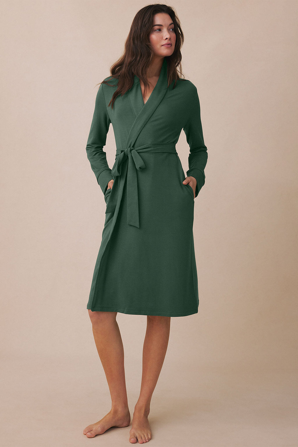 Green wrap robe with long sleeves, tie waist, and front pockets worn by model against neutral background.