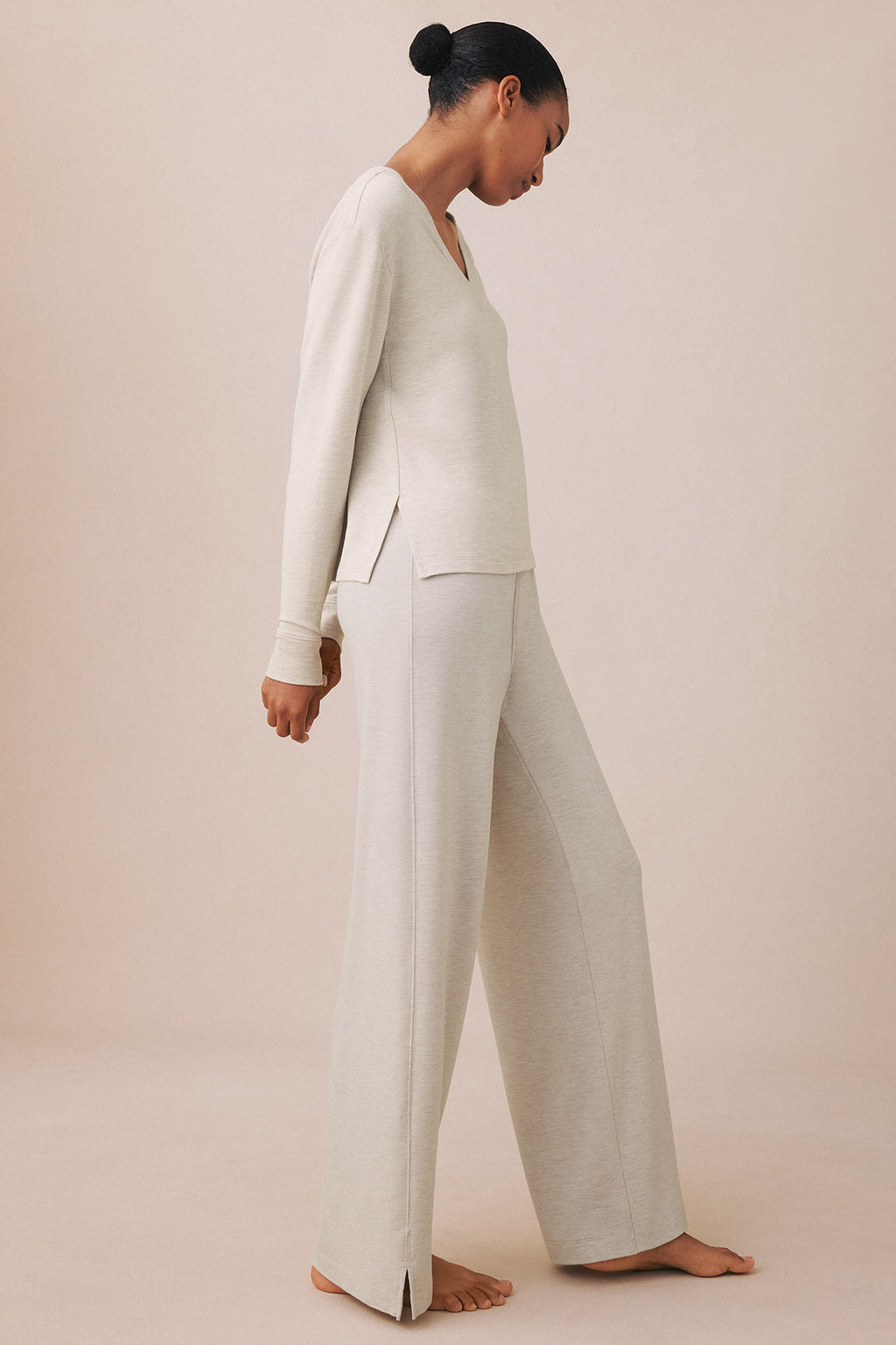 Oat heather v-neck long-sleeve top and wide-leg pants shown on model in side profile.