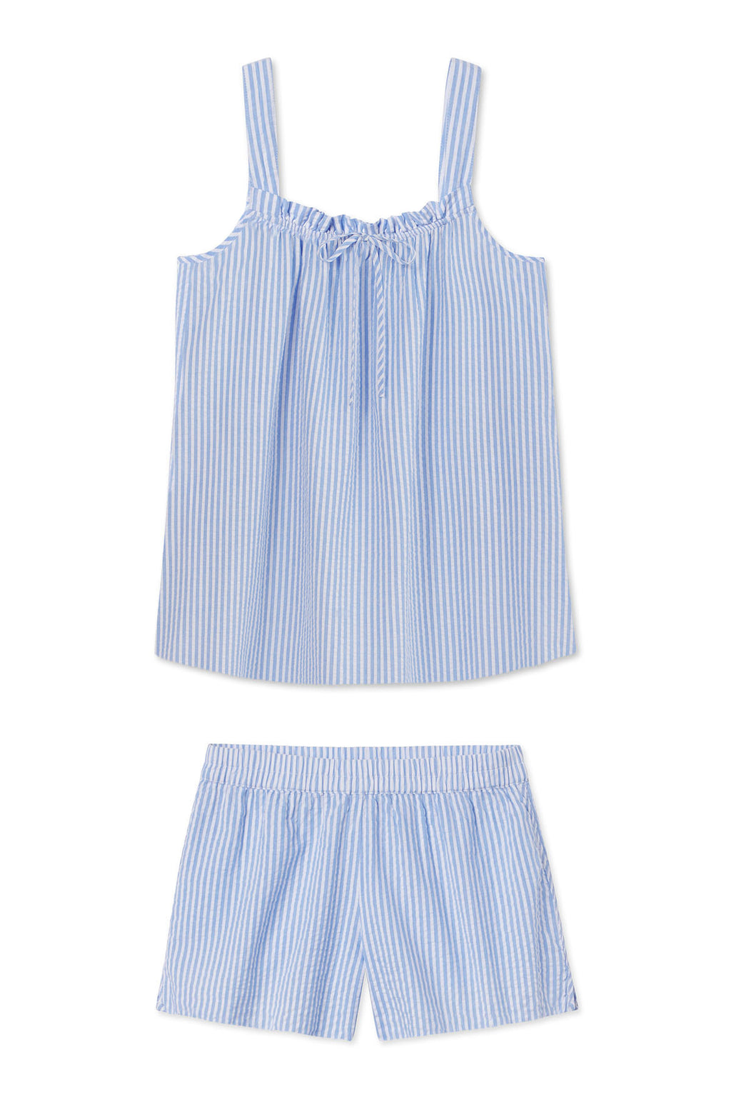 The Alice Shorts Set in Blue Seersucker features a light blue and white vertical striped sleeveless top with a ruffle neckline and matching elastic waist shorts, shown flat on a white background.
