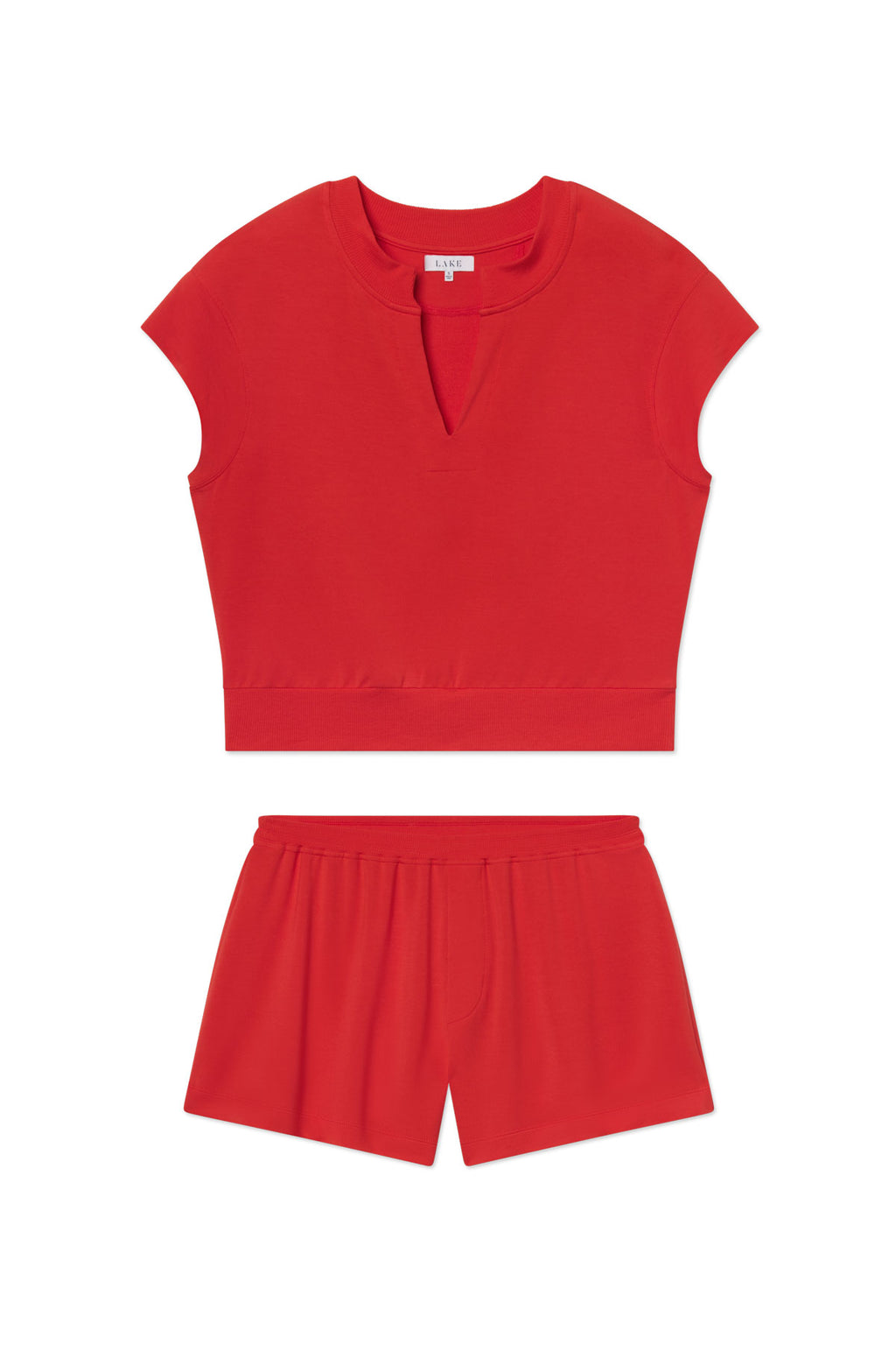 The Relax Short Sleeve Shorts Set in Tart features a matching red short-sleeve V-neck crop top and elastic-waist modal shorts, displayed flat on a white background.