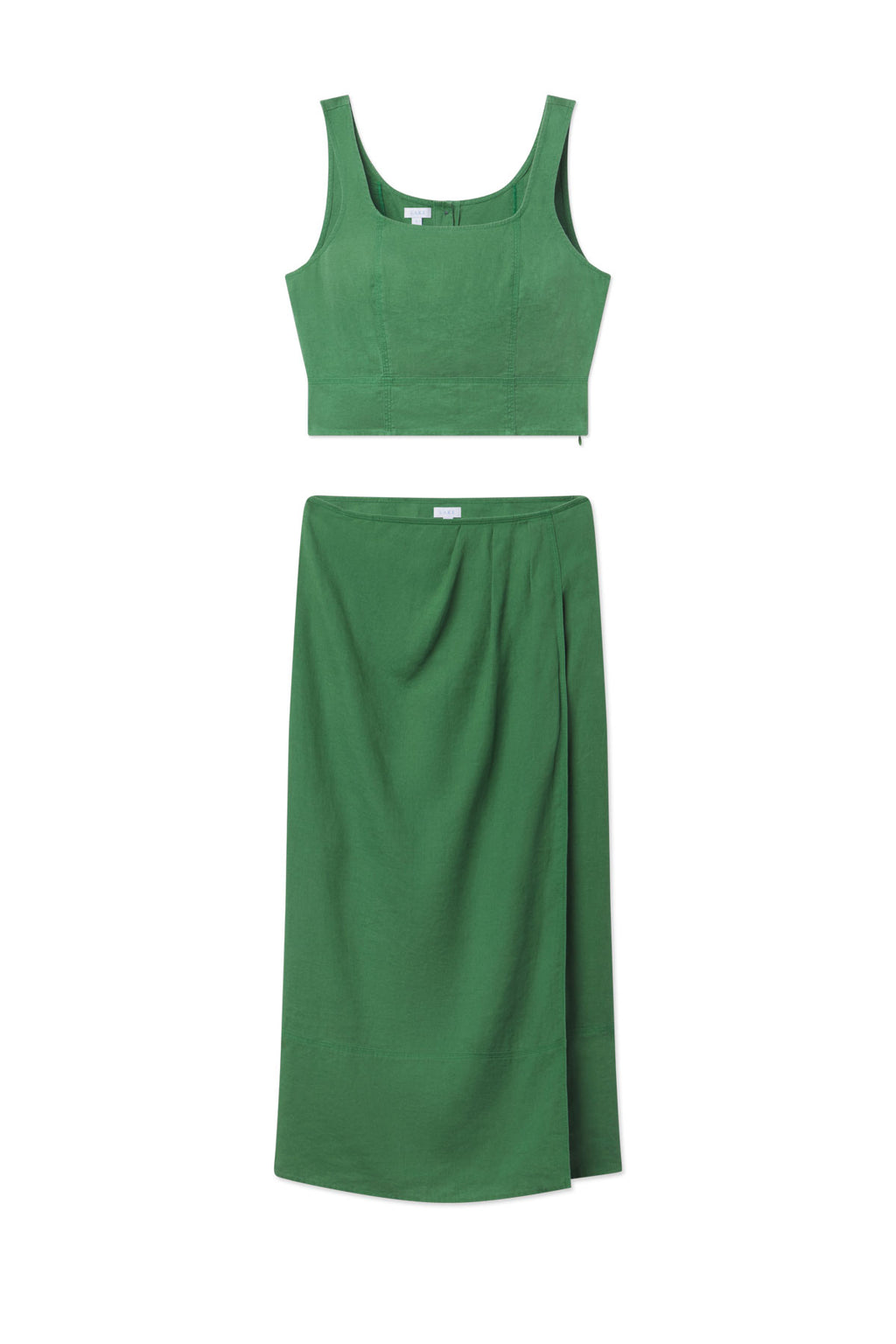 The Flute Skirt Set in Palm features a tailored fit, sleeveless crop top with wide straps, and a high-waisted, knee-length skirt with a slight overlap detail.