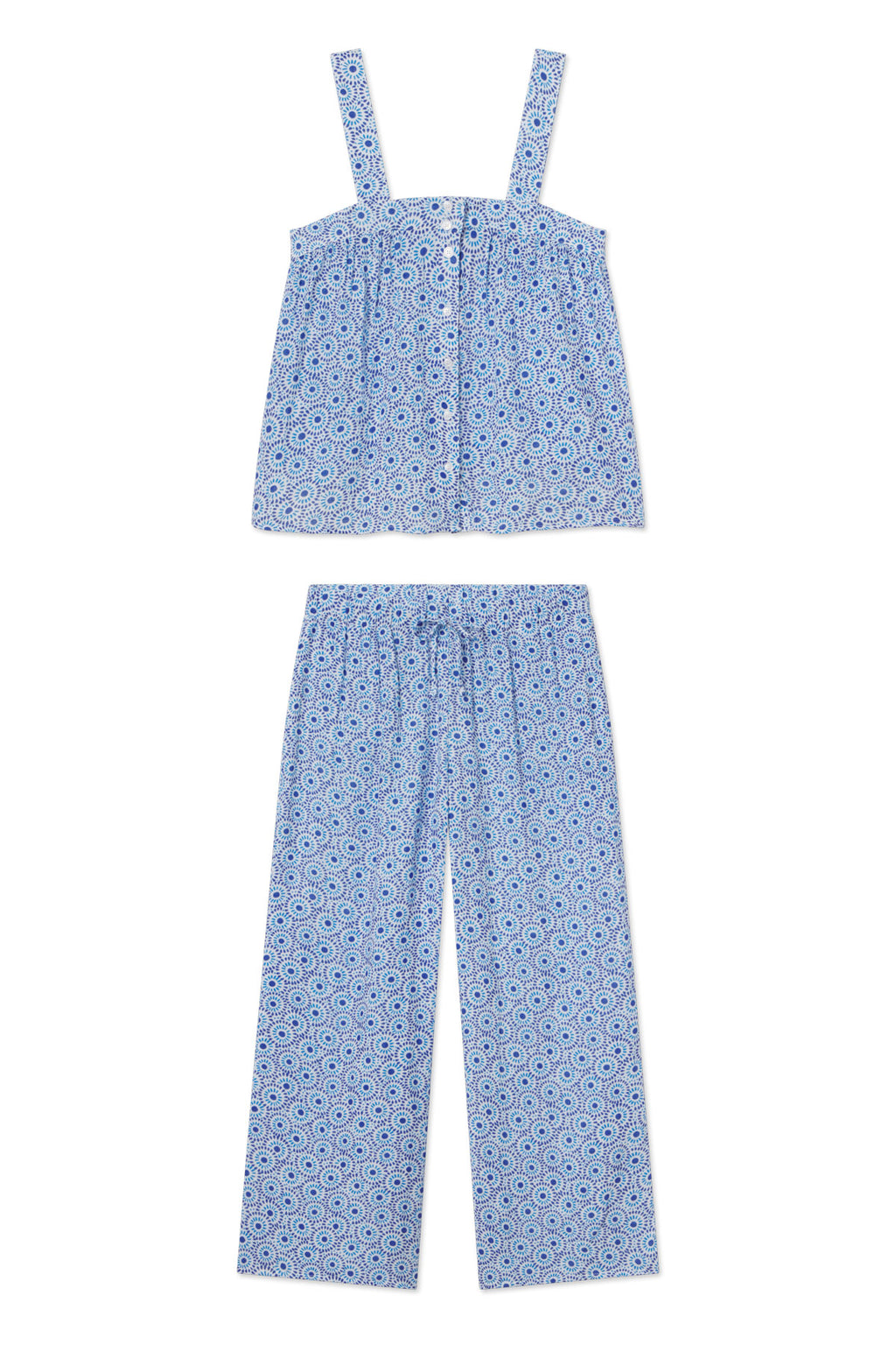 The Hamptons Pants Set in Lapis Dot Gauze showcases a blue and white dot pattern with a sleeveless, button-front top and wide-leg pants. Crafted from breathable gauze, both pieces are displayed flat on a white background—ideal for hot sleepers.