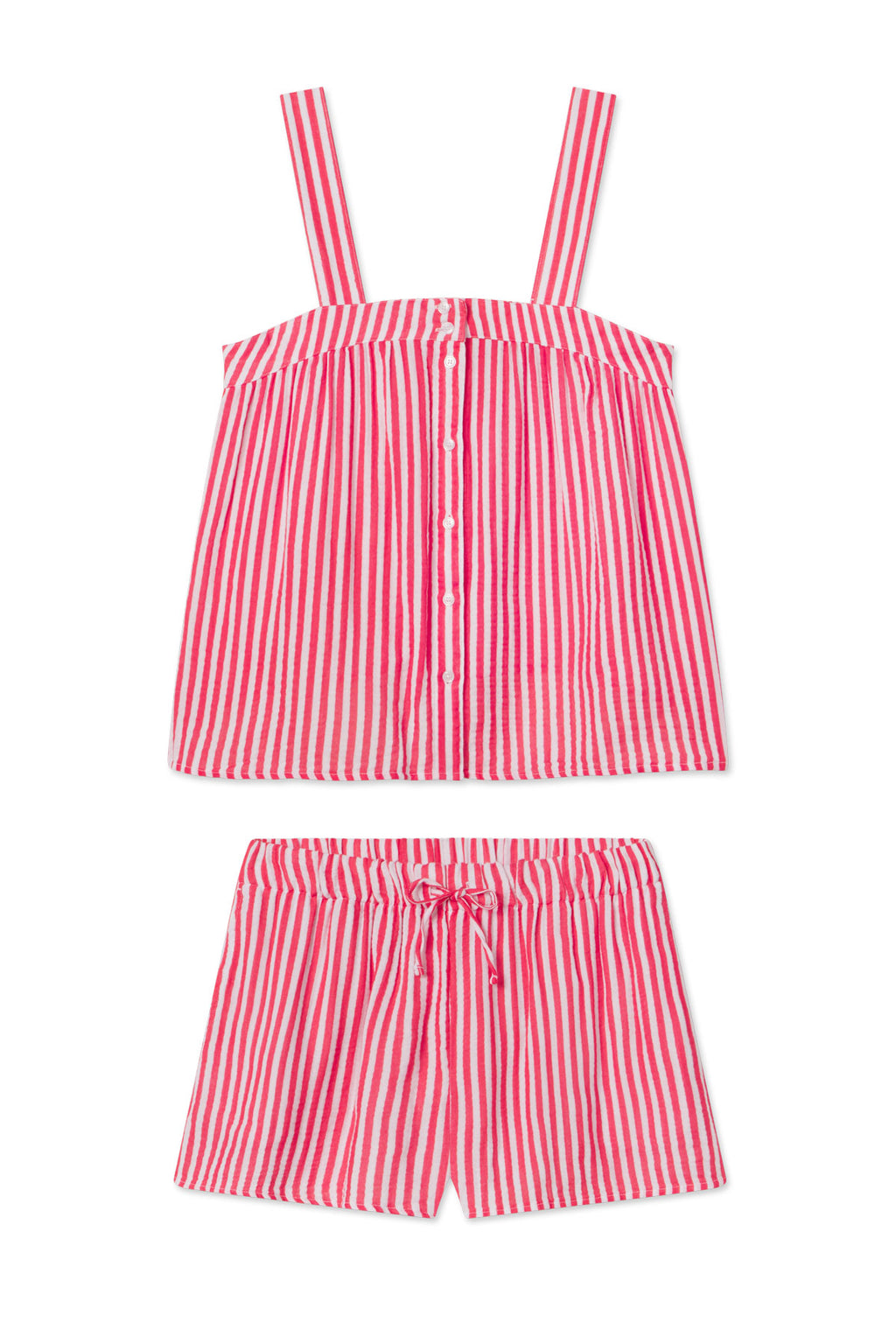 The Hamptons Shorts Set in Bougainvillea Stripe Gauze features pink and white stripes, a sleeveless button-up top with wide straps, and drawstring shorts—both in a loose, comfy fit perfect for hot sleepers.