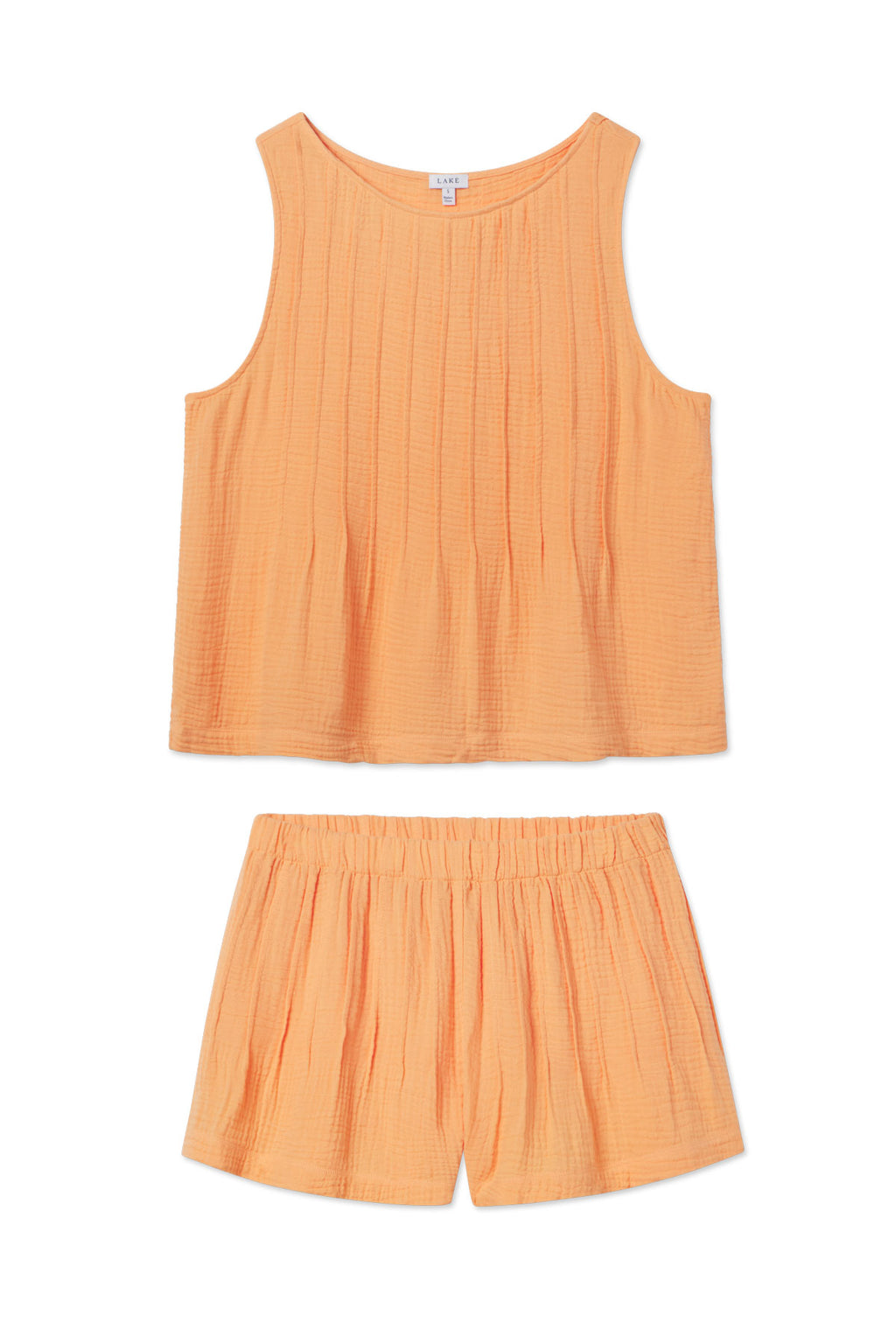 The Monaco Shorts Set in Marigold Gauze, featuring a matching sleeveless tank top and cotton gauze shorts in lightweight, slightly crinkled fabric, is laid flat on a white background.