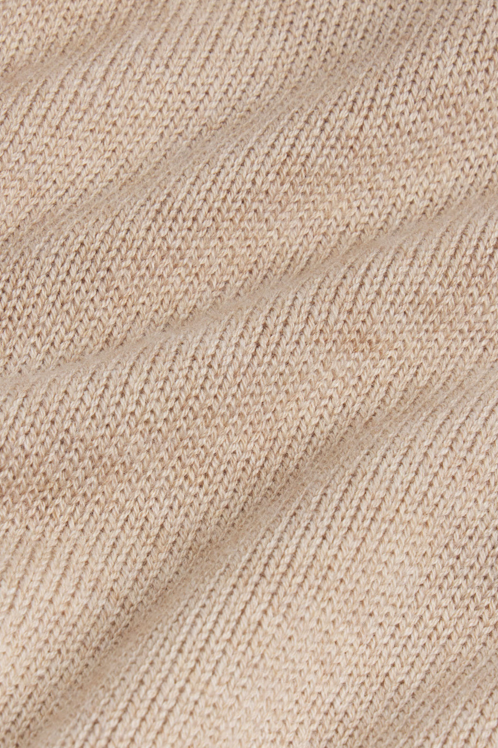 Ginger heather knit fabric with diagonal ribbed texture and woven pattern.