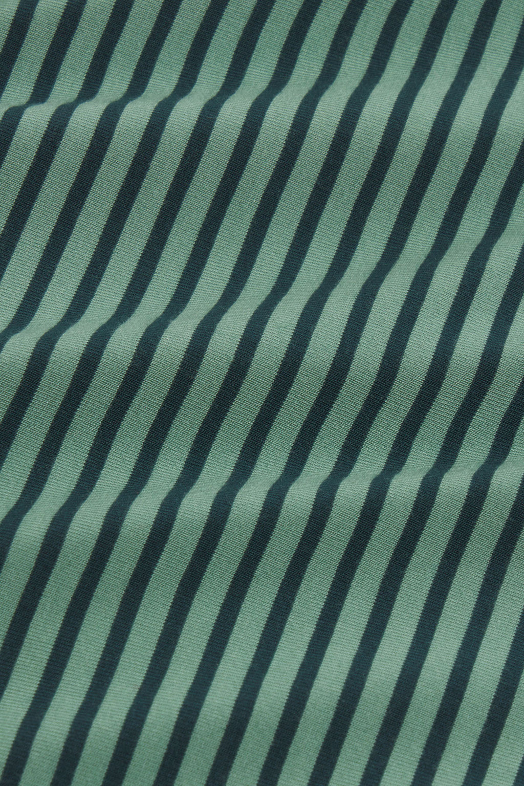 Green and dark blue striped fabric with vertical pencil stripes and textured weave.