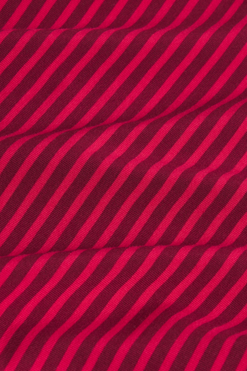 Burgundy and hot pink diagonal striped fabric with textured weave pattern.