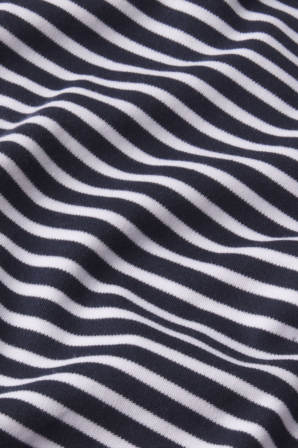 Close-up of black and white Eclipse Voyager Stripe fabric with gentle folds and soft texture, featured in the Men