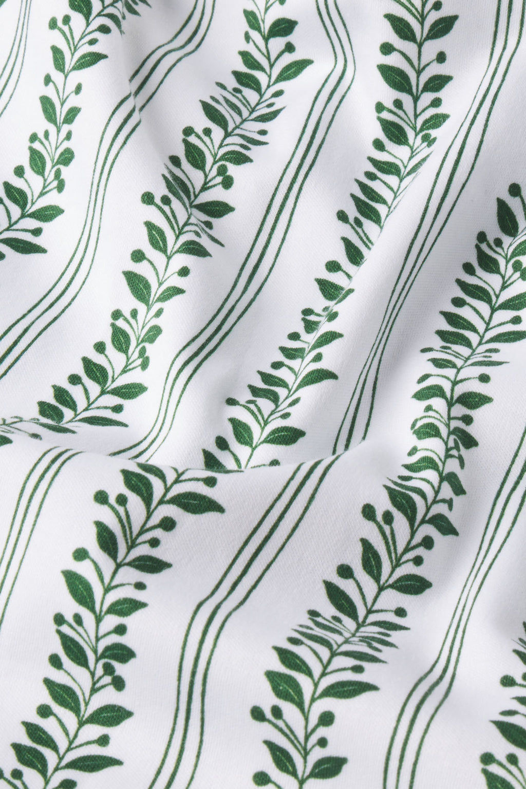 The Pima Ruffle Pants Set in Eden Jasmine Vine features soft white Pima cotton with green leafy vines and lines for a botanical look, perfect for wide-leg pants or a coordinated set.