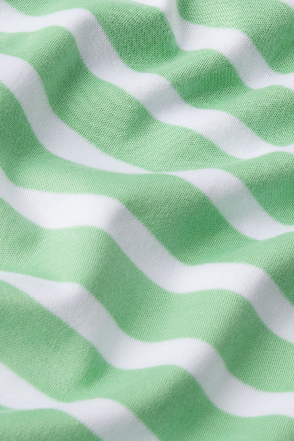 A close-up of the Kids Long-Long Set in Field Green Hull Stripe shows soft Pima cotton fabric with green and white horizontal stripes, highlighting its texture and gentle folds—ideal for cozy kids