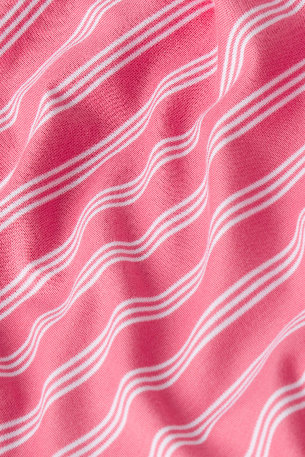 Close-up of the Pima Ruffle Pants Set in Winterberry Triple Stripe, featuring soft pink Pima cotton with white parallel stripes and a gently textured, slightly wrinkled finish that enhances the stripe pattern.