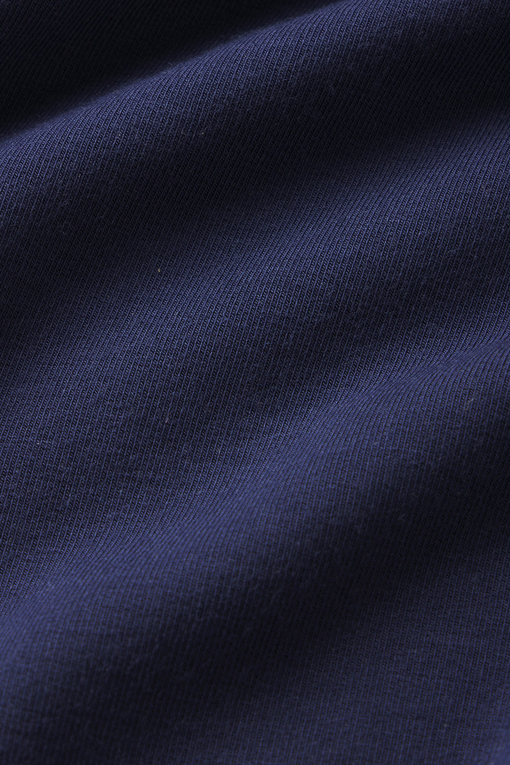 Close-up of the Relax Pants Set in English Navy, highlighting the fabric’s subtle ribbed texture and gentle folds.