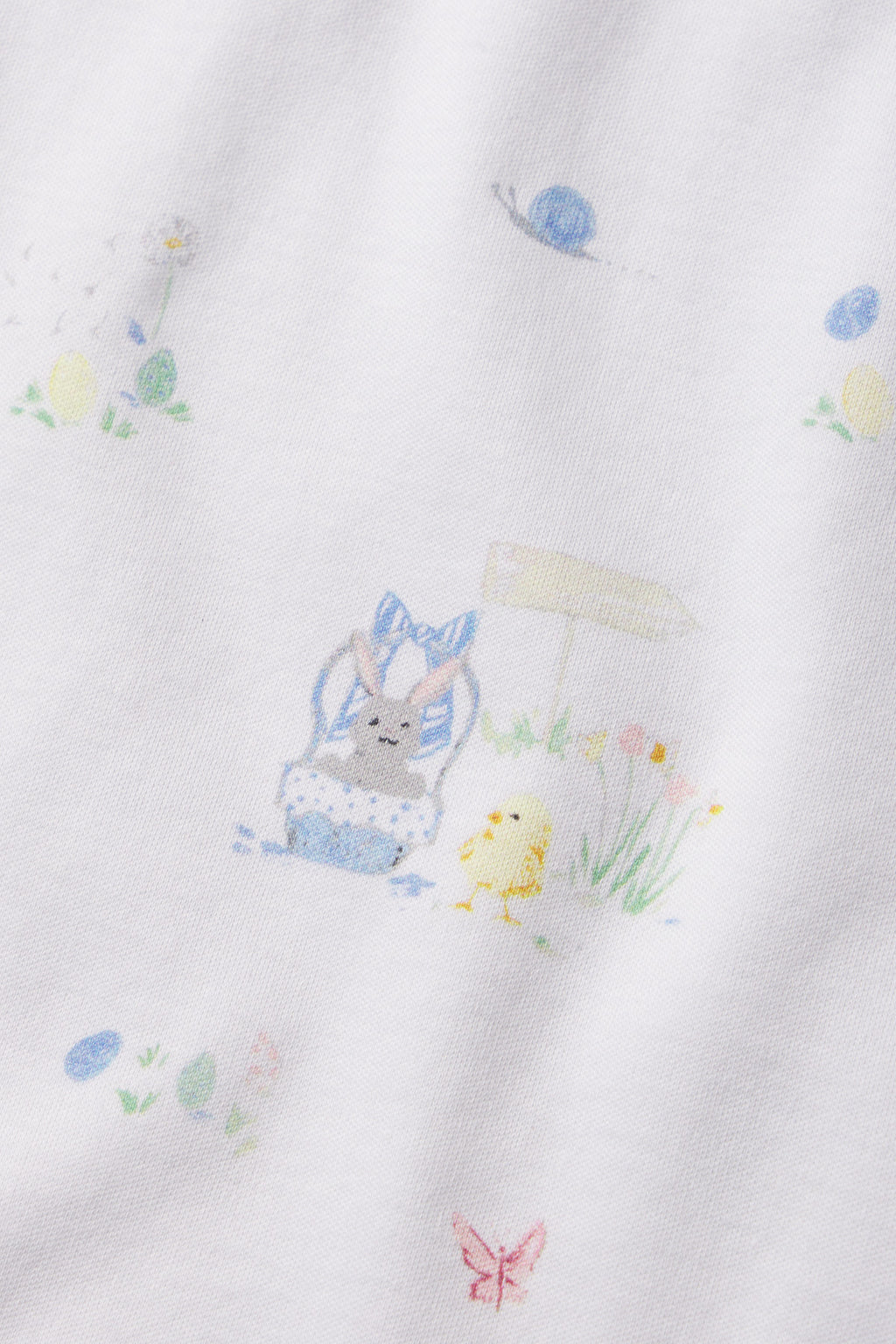 The Kids Shorts Set in Easter Egg Hunt is made from 100% Pima cotton and features a pastel bunny with a blue bow, yellow chick, flowers, Easter eggs, butterflies, and blue snails—perfect for spring celebrations.