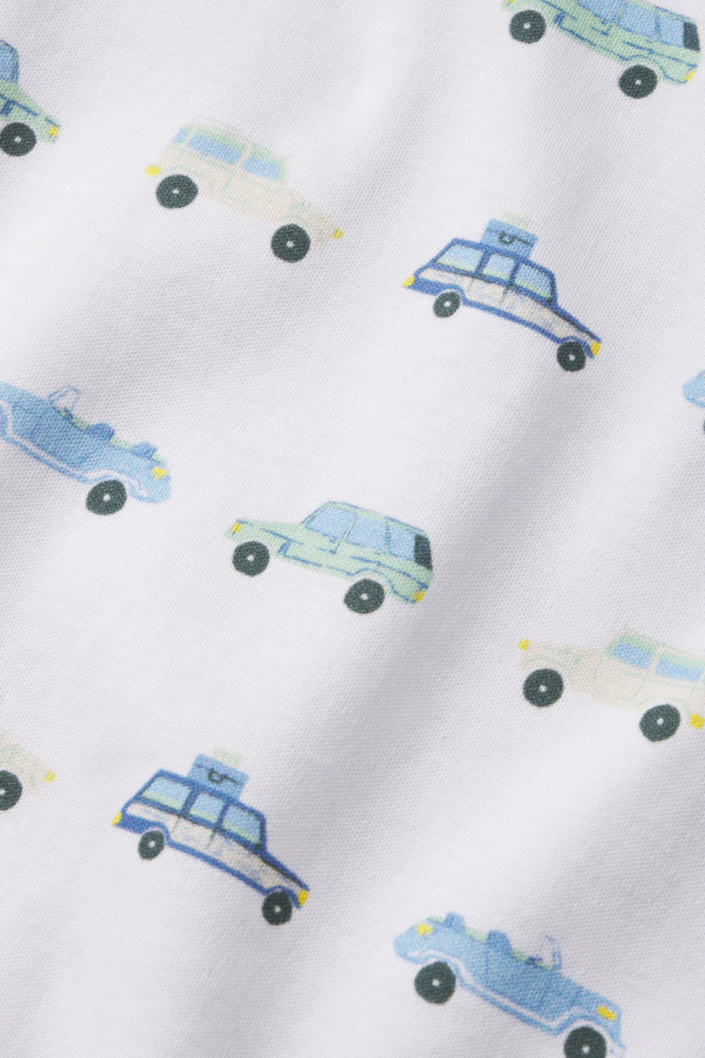 The Kids Long-Long Set in Off Road Cruisers features white Pima cotton fabric with a soft, slightly textured feel and a playful pattern of blue, green, and beige cartoon off-road cruisers—some with luggage on top.