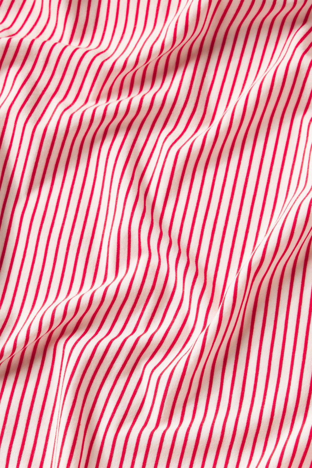 The DreamModal Short Robe in Ski Patrol Stripe features red and white stripes with gentle folds and wrinkles, offering a buttery soft feel for ultimate comfort.
