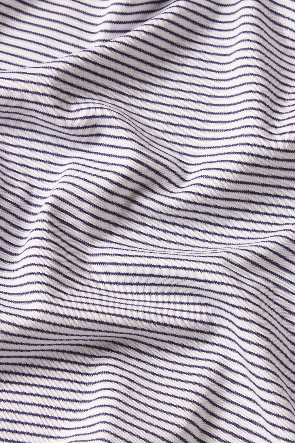 The Pima Short Robe in English Navy Stripe features white fabric with thin, evenly spaced horizontal navy stripes, softly draped and crafted from 100% luxe Pima cotton for exceptional comfort.